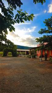 a view of a building with trees in the foreground at Pousada do Nondas in Nobres