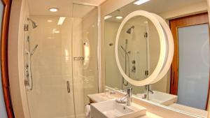 a bathroom with a shower and a sink and a mirror at SpringHill Suites by Marriott Scranton Montage Mountain in Moosic