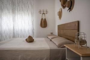 a bedroom with a bed with a hat on it at Perla Marina Appartamento in Rimini