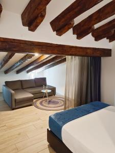 a bedroom with a bed and a couch at Hotel El Siglo in Valencia