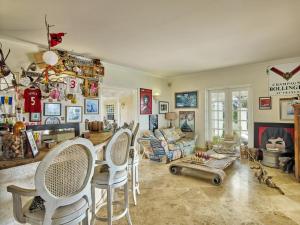 a living room with a table and chairs and a fireplace at Larimar - Luxury Ocean Front Villa in Saint Philip