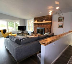 a living room with a couch and a fireplace at PA Sea View Deck House in Port Angeles