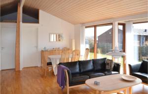 a living room with a couch and a table at Awesome Home In Rnde With 3 Bedrooms And Wifi in Rønde