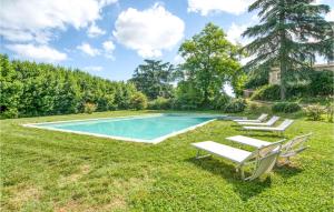 a swimming pool with lounge chairs in the grass at Alfina 3 in Castel Giorgio