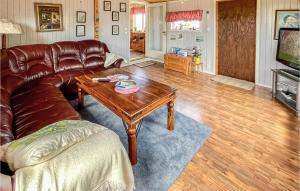 a living room with a leather couch and a coffee table at 2 Bedroom Cozy Home In Degerhamn in Degerhamn