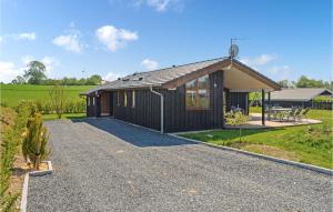 a house with a gravel driveway in front of it at Stunning Home In Rnde With Kitchen in Rønde