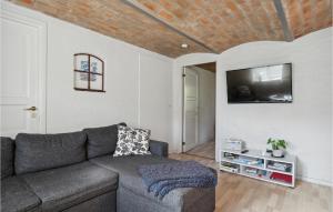 a living room with a couch and a flat screen tv at 2 Bedroom Pet Friendly Apartment In Ringkbing in Ringkøbing