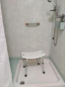 a bathroom with a shower with a white tub at Bed and Breakfast La Campanula in Vittorito