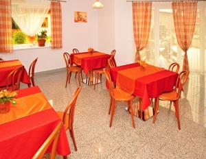 a dining room with red tables and chairs at Apartmany Broma in Liptovský Mikuláš +31 photos
