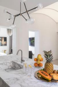 a kitchen counter with a pineapple and fruits on it at Luxe Rome apartment in Rome