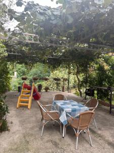 a patio with a table and chairs and a playground at Apartments Suzana in Herceg-Novi