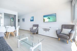 een woonkamer met een glazen tafel en stoelen bij Santa Margarita Deluxe 14-C Levante Beach in Benidorm