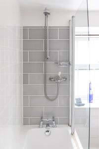 a shower in a bathroom with a sink at The Georgian House in Alderney