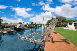 a boat docked on a dock in a canal at Dania Beach Unit 1 By Pmi in Dania Beach