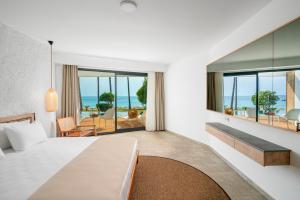 a hotel room with a bed and a view of the ocean at Yalihan Aspendos in Alanya +54 photos