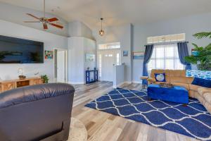 a living room with a couch and a blue rug at Fort Pierce Escape Beach-Entry Pool, Waterslide! in Fort Pierce