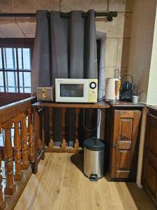a microwave sitting on a counter in a kitchen at Hotel Robin Quantin in the heart of Old Tours in Tours