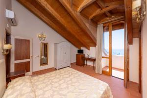 a bedroom with a bed and a view of the ocean at Villa Isabella Minori in Minori