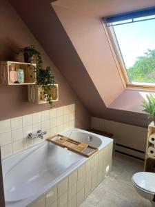 a bathroom with a large bath tub in a attic at Ark van Thesinge 