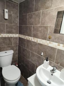 a bathroom with a toilet and a sink at Studio Apartment at Chadwell Heath in Romford