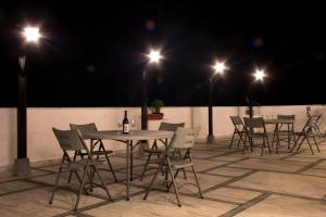 a group of tables and chairs on a patio at night at Hotel Bhutan Ga Me Ga in Phuntsholing