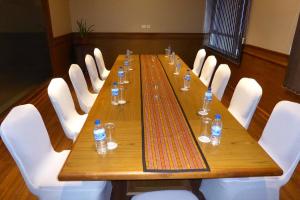 a long wooden table with bottles of water on it at Hotel Bhutan Ga Me Ga in Phuntsholing