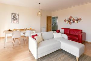 a living room with a couch and a table at Sunset Retreat in Nazaré