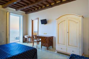 a room with a desk and a table and a window at Villa Isabella Minori in Minori