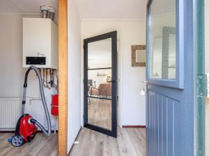 an open door in a room with a vacuum at Cozy holiday home in Den Burg with hot tub in Den Burg