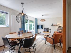 a living room with a table and chairs at Cozy holiday home in Den Burg with hot tub in Den Burg