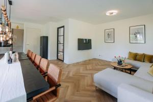 a living room with a couch and a table at Brand new luxurious 6 bedroom villa in Amsterdam in Amsterdam