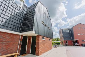 a building with a black roof on top of it at Brand new luxurious 6 bedroom villa in Amsterdam in Amsterdam