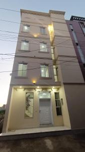 a tall building with a white door and windows at Continental Boys Hostel R-2 Johar Town in Lahore