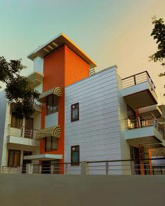 a building with an orange and white at BED LUCKS near Huda Metro sector 40 in Gurgaon