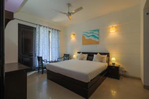 a bedroom with a bed and a table and chairs at BED LUCKS near Huda Metro sector 40 in Gurgaon