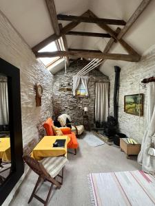a living room with a stone wall at Quirky Tiny Home in York Moors in York
