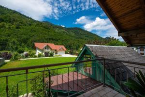 a balcony with a view of a house and a mountain at Ferienhaus Englacher in Ebensee