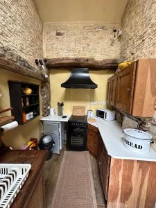 a small kitchen with a stove and a sink at Quirky Tiny Home in York Moors in York