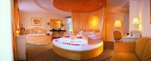 a bedroom with a large bed with pillows on it at ... mein romantisches Hotel Toalstock in Fiss