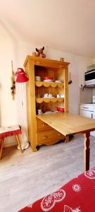 a wooden cabinet with a table in a room at STUDIO 4 personnes in Les Prés