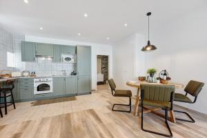 a kitchen with blue cabinets and a table and chairs at Villa Xique 11 in Monchique