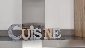 a metal sign that reads qentesis sitting on a counter at A&D apartments in Bologna