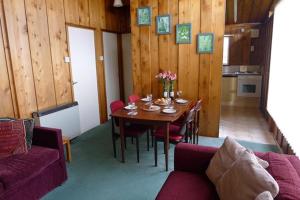 a dining room with a table and a couch at 9 Timber Hill in Broad Haven