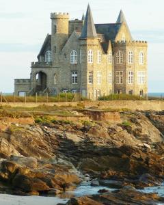 an old castle on the shore of a beach at Mobil home Cygne 85 in Quiberon