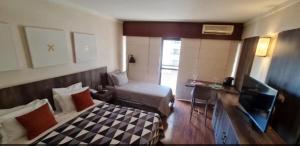 TV a/nebo společenská místnost v ubytování Hotel Paulista Plaza MCR