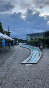 a street with a fountain in the middle of a road at Hôtel Marie Louise in Enghien-les-Bains