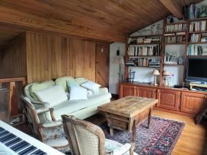 a living room with a couch and a table at Chalet Nicouski in La Salle Les Alpes +36 photos