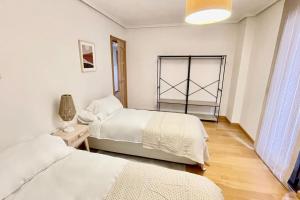 a bedroom with two beds and a window at Quartier León VUT-LE-946 in León