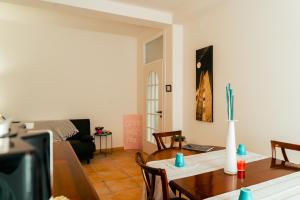 a living room with a table and a dining room at La Terrazza sul Reno - in pieno centro-due passi da Villa Chiara - comodo Unipol Arena in Casalecchio di Reno