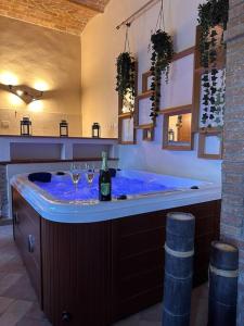 eine Badewanne mit zwei Weingläsern und einer Flasche Wein in der Unterkunft Relax nella jacuzzi in Toscana in Colle di Val d’Elsa